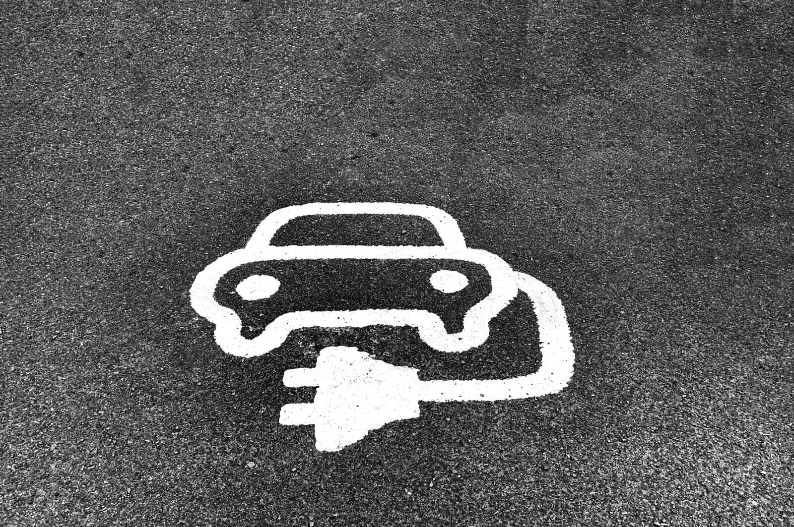 Car charging point symbol painted on tarmac