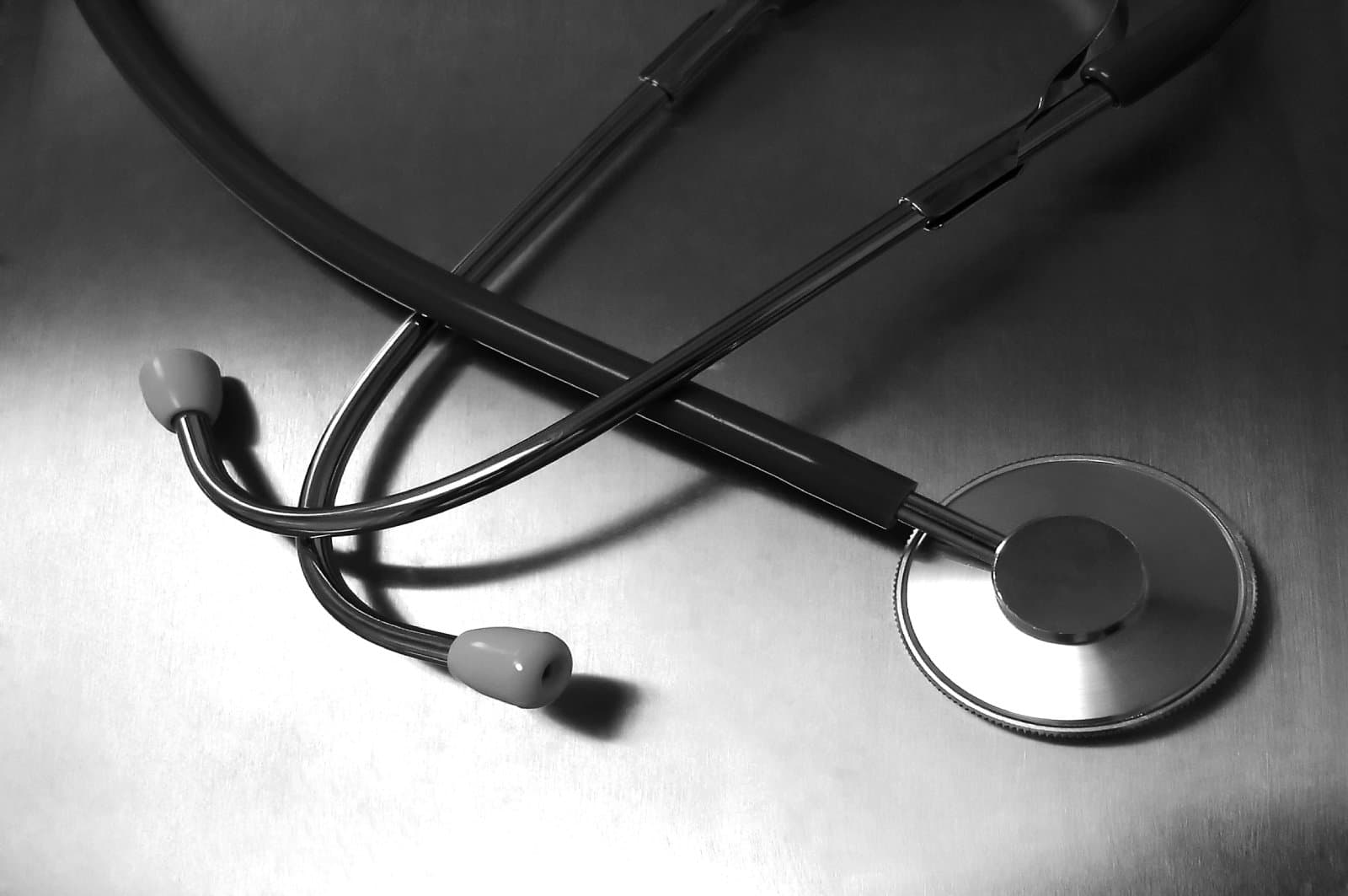 Close up of a stethoscope laying flat on a metal table