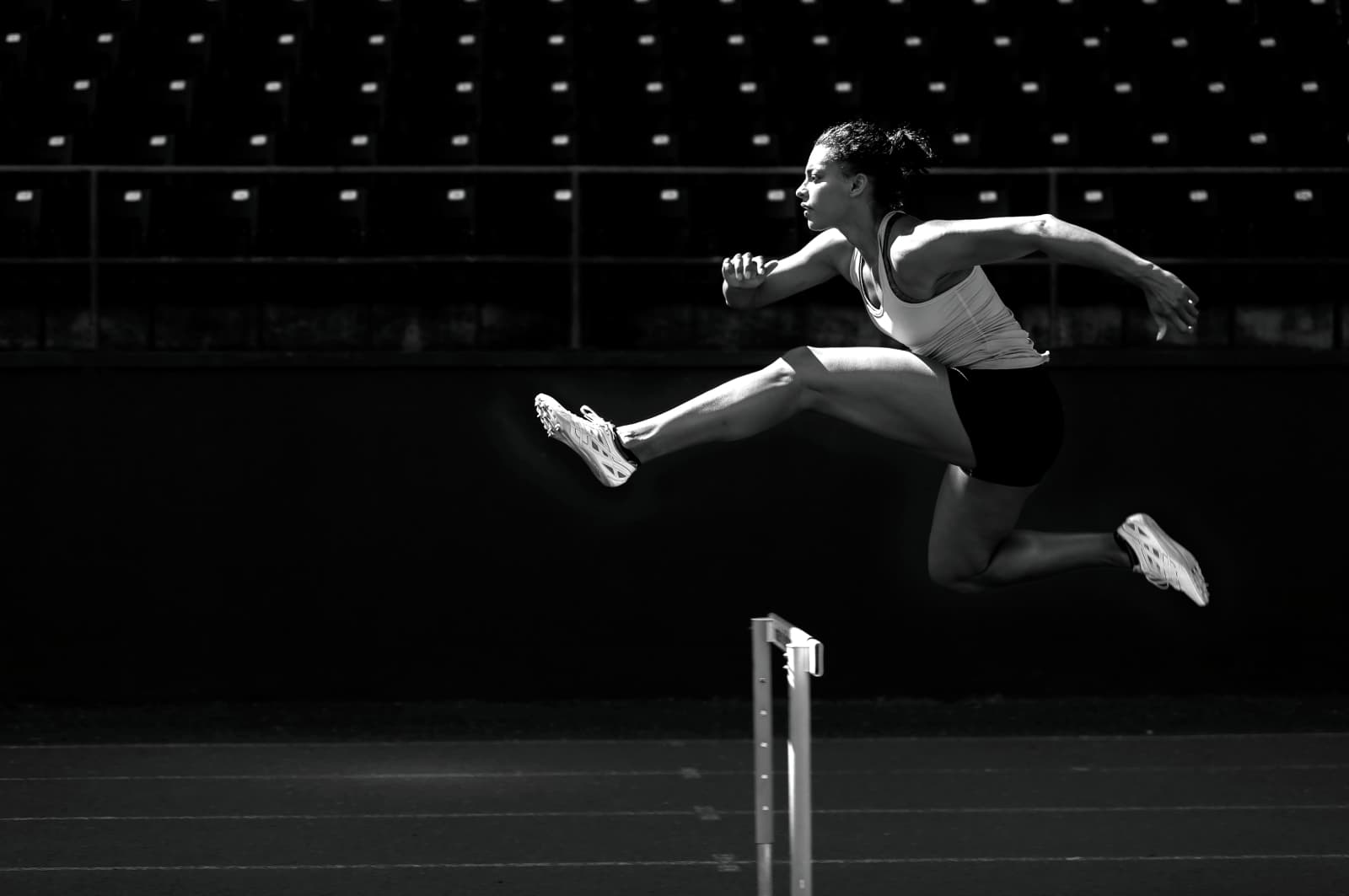 A person jumping over a hurdle in a race