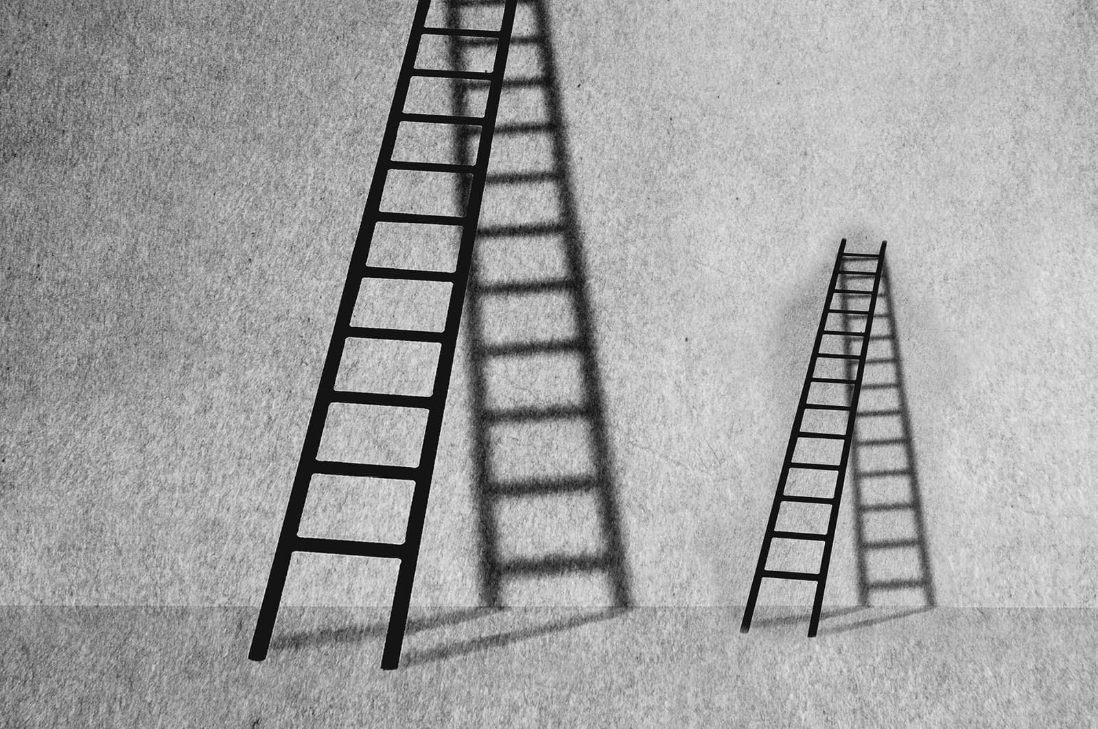 two ladders leaning against a wall