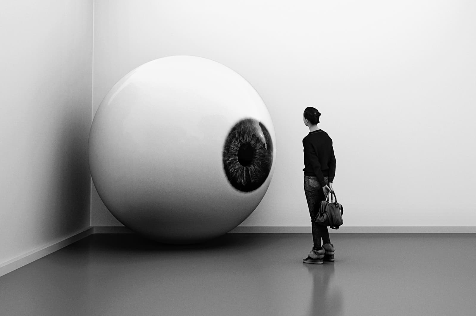 A person looking at a sculpture of an eyeball